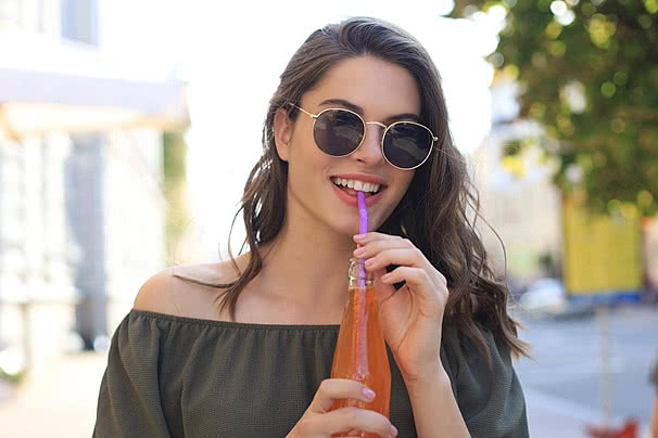 files/pngtree-outdoorsy-young-woman-sporting-shades-confidently-posing-with-a-juice-bottle-meets-the-camera-gaze-photo-image_42709010.jpg